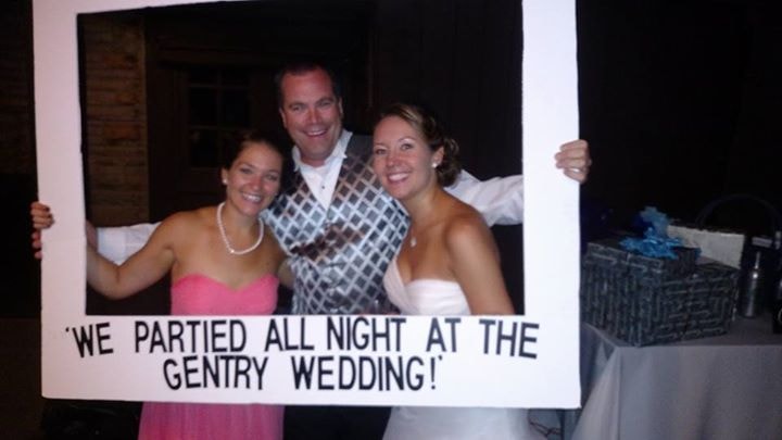 Wedding guests posing behind a Gentry wedding photo frame